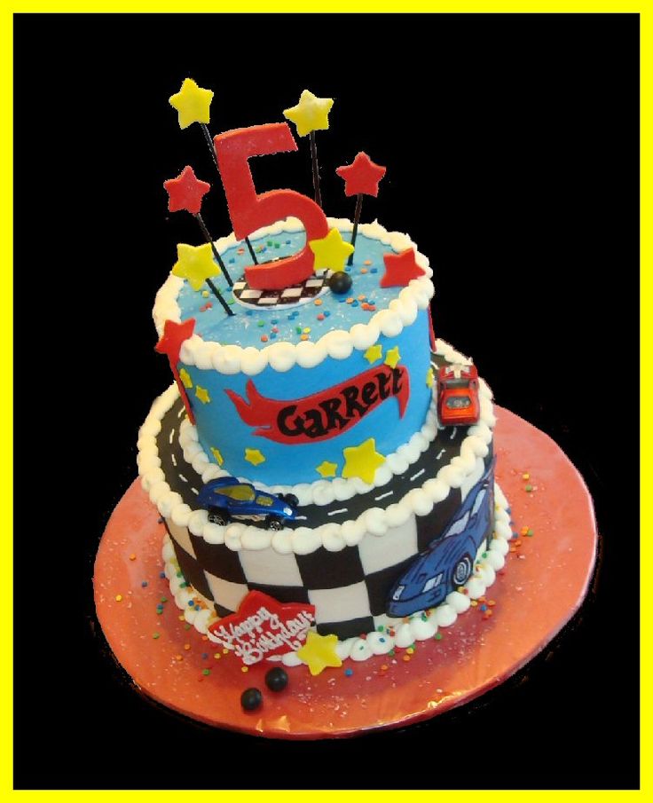 a birthday cake for a five year old boy with the number five on top and stars