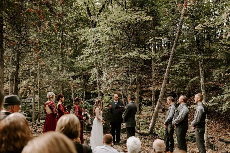 a group of people that are standing in the woods