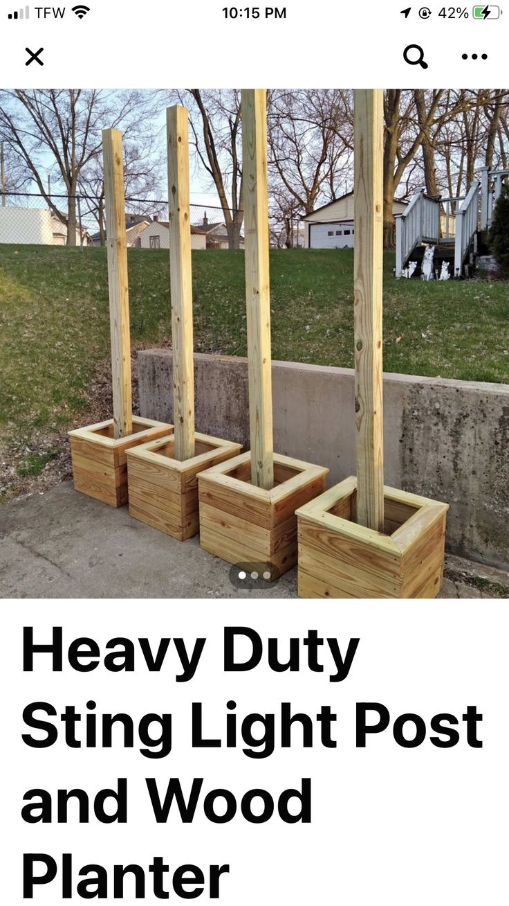 some wooden planters sitting on the side of a road with text overlay that reads heavy duty string light post and wood planter