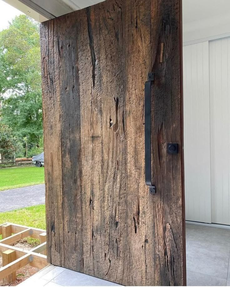 the door is made out of wood and has an iron handle on it's side