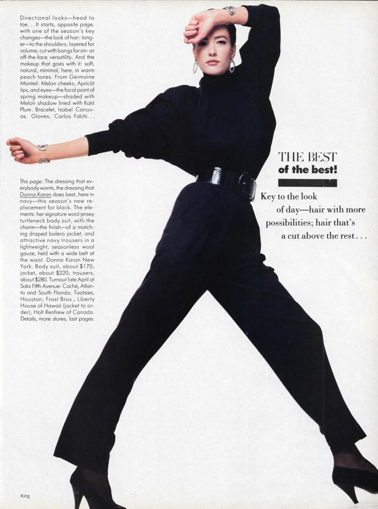 a woman in black jumpsuits and heels is posing for the camera with her arms outstretched