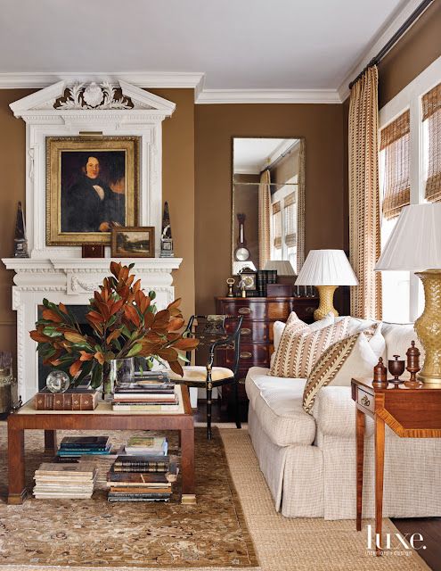 a living room filled with furniture and a fire place in the middle of a room