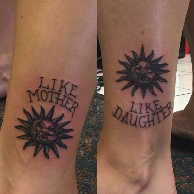 two tattoos on both legs that say like mother, like daughter and sun with skull