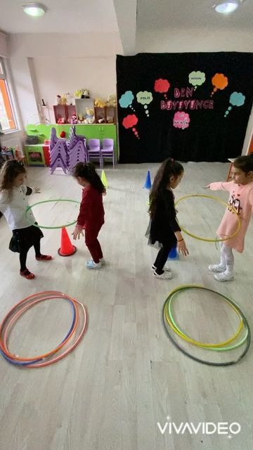 children playing with hula hoops in an indoor play area