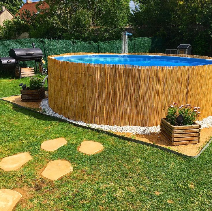 an above ground pool surrounded by grass