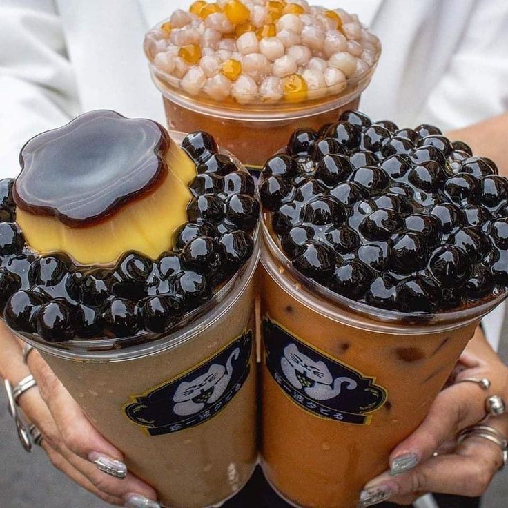 two people holding cups filled with ice cream and jelly