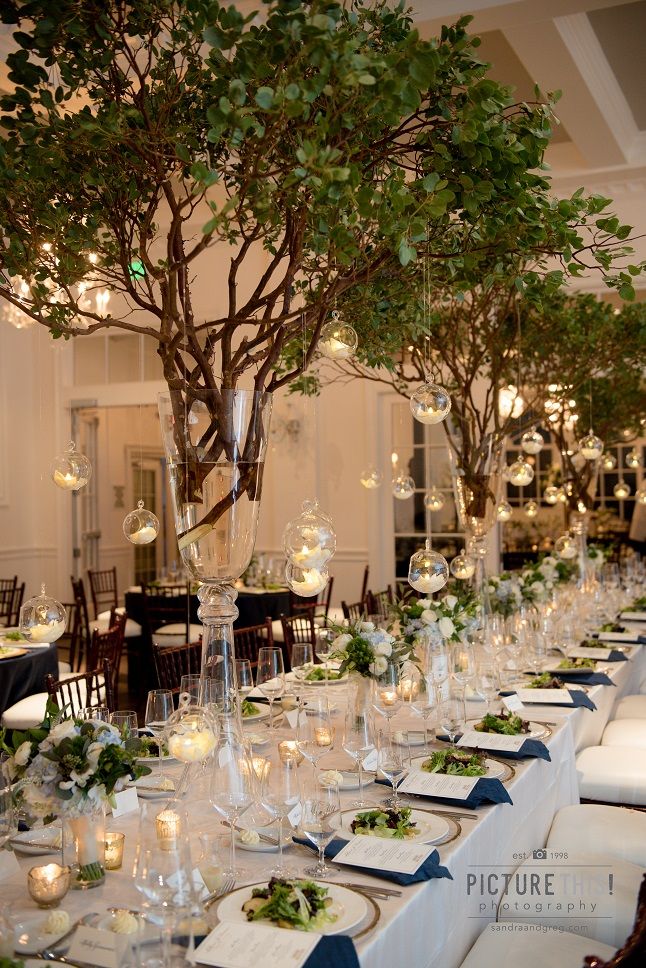 a long table is set up with place settings and centerpieces for an event