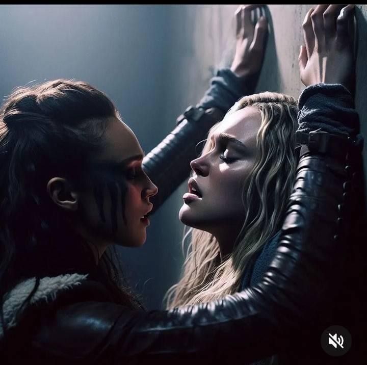 two women in black leather jackets touching each other's foreheads and looking at one another