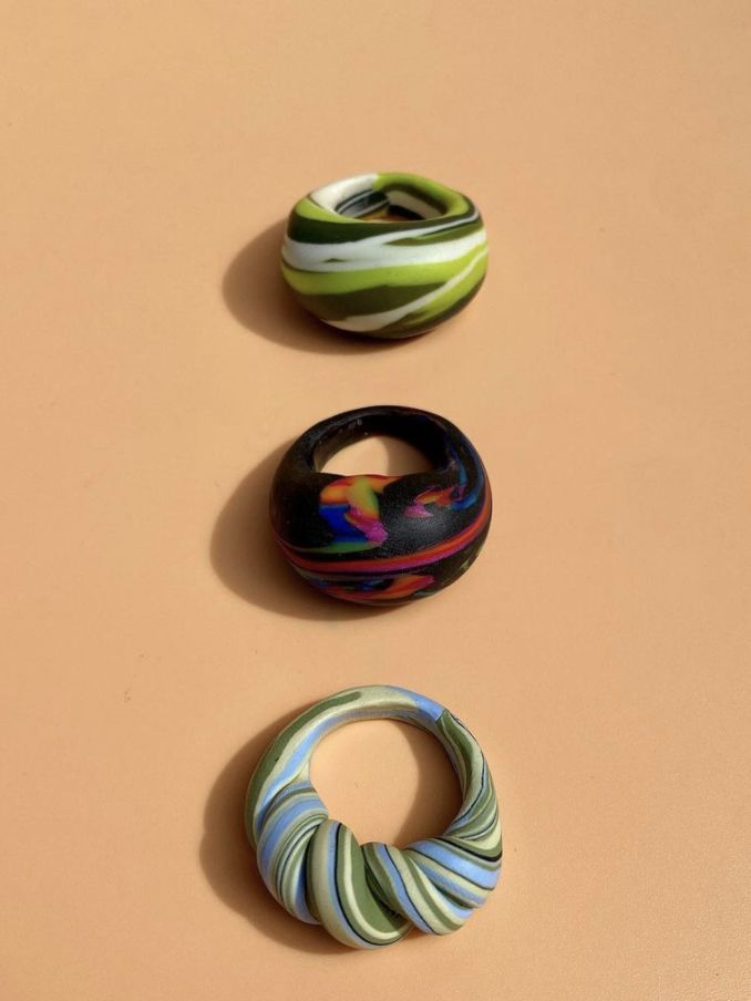 three different colored rings sitting on top of a table