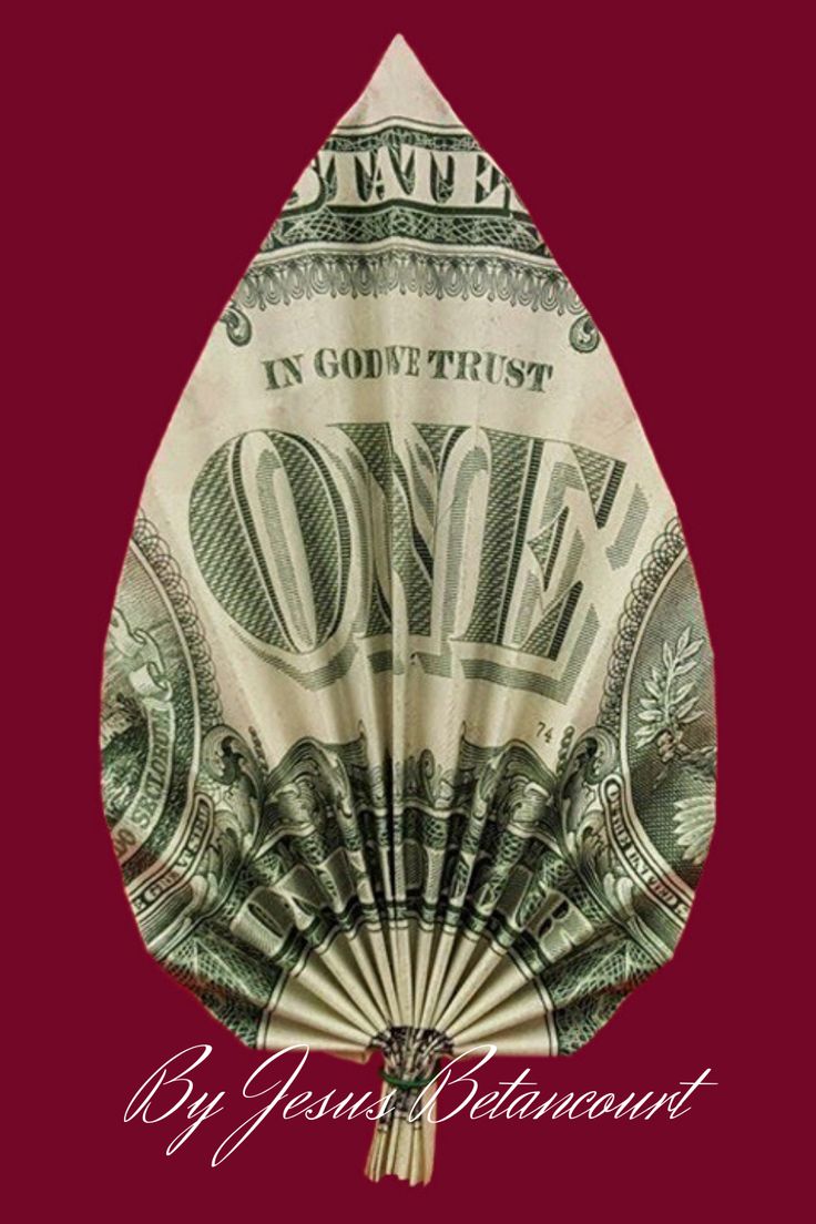 a fan made out of money sitting on top of a red background with the words in god