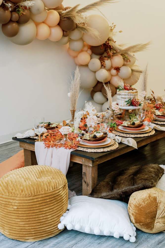 a table is set up with plates and desserts for an autumn themed birthday party