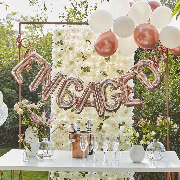 a table topped with balloons and wine glasses