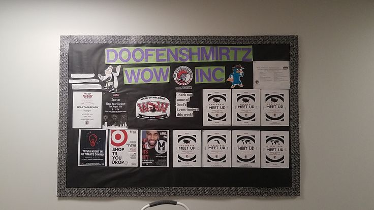 a bulletin board with various stickers on it