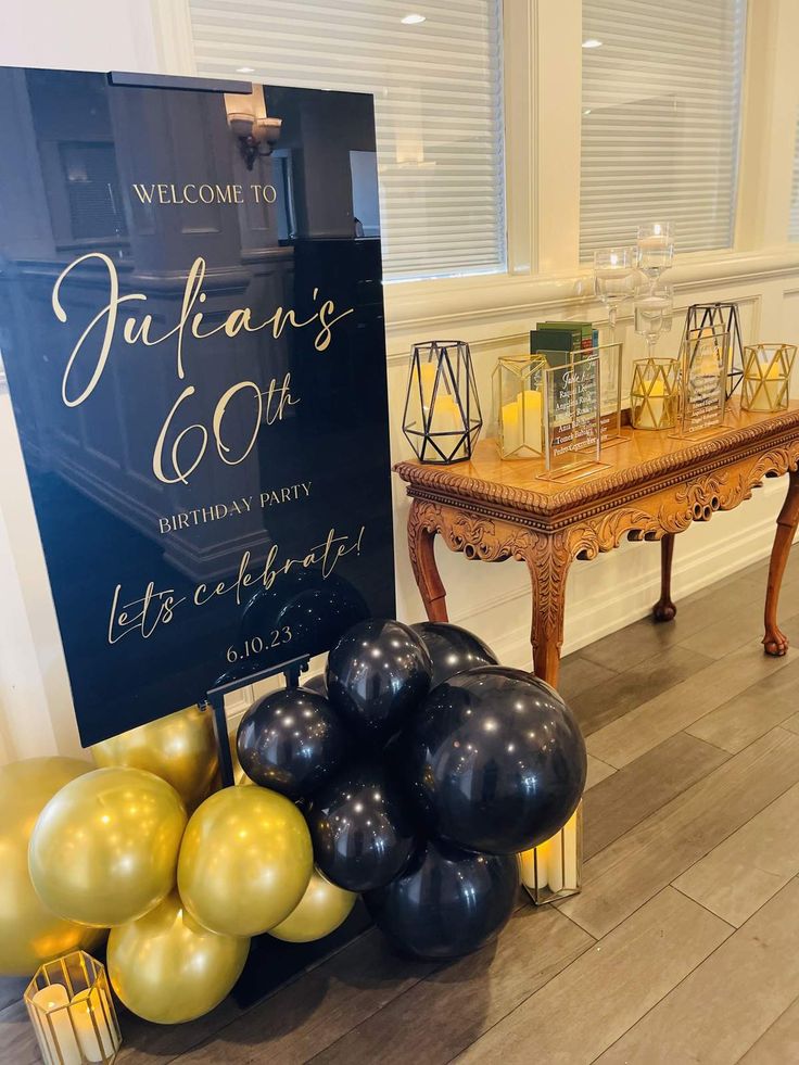 a welcome sign and balloons in front of a table