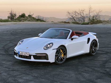 a white sports car parked in a parking lot