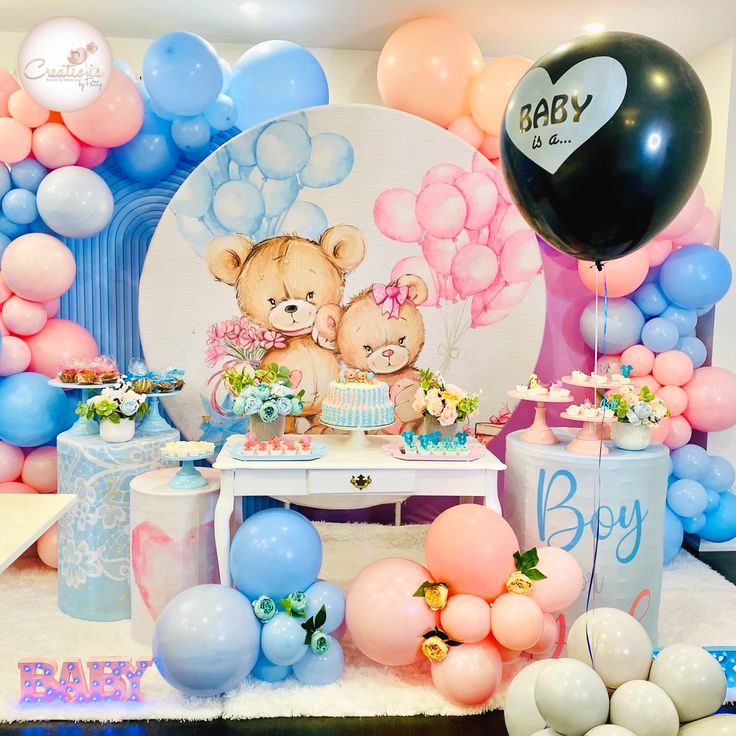 a baby shower party with balloons, cake and teddy bears on the table in front of it