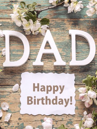 a happy birthday card with the words dad written on it and flowers around it in front of a wooden background