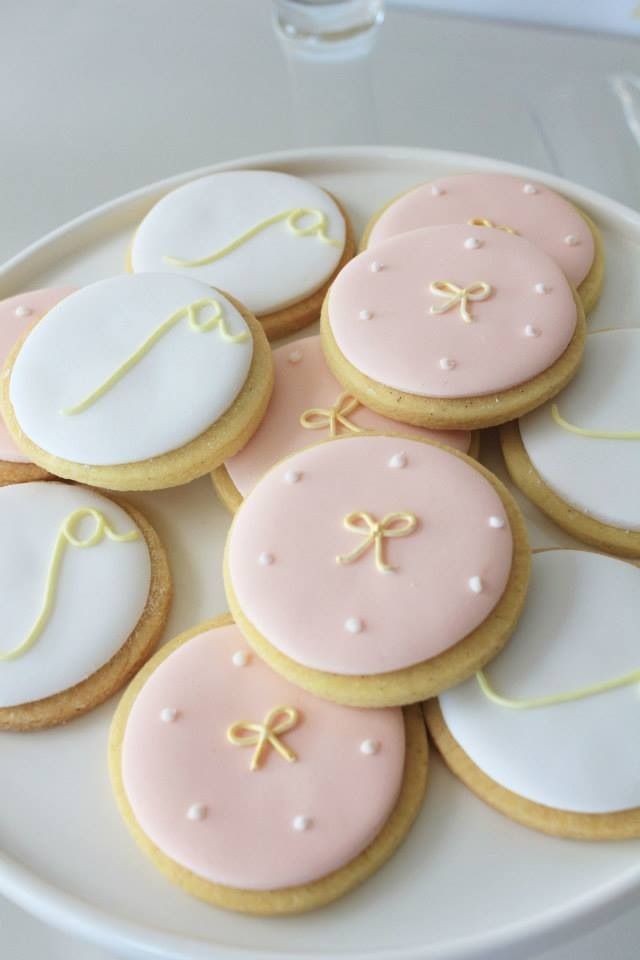 a white plate topped with cookies covered in frosting