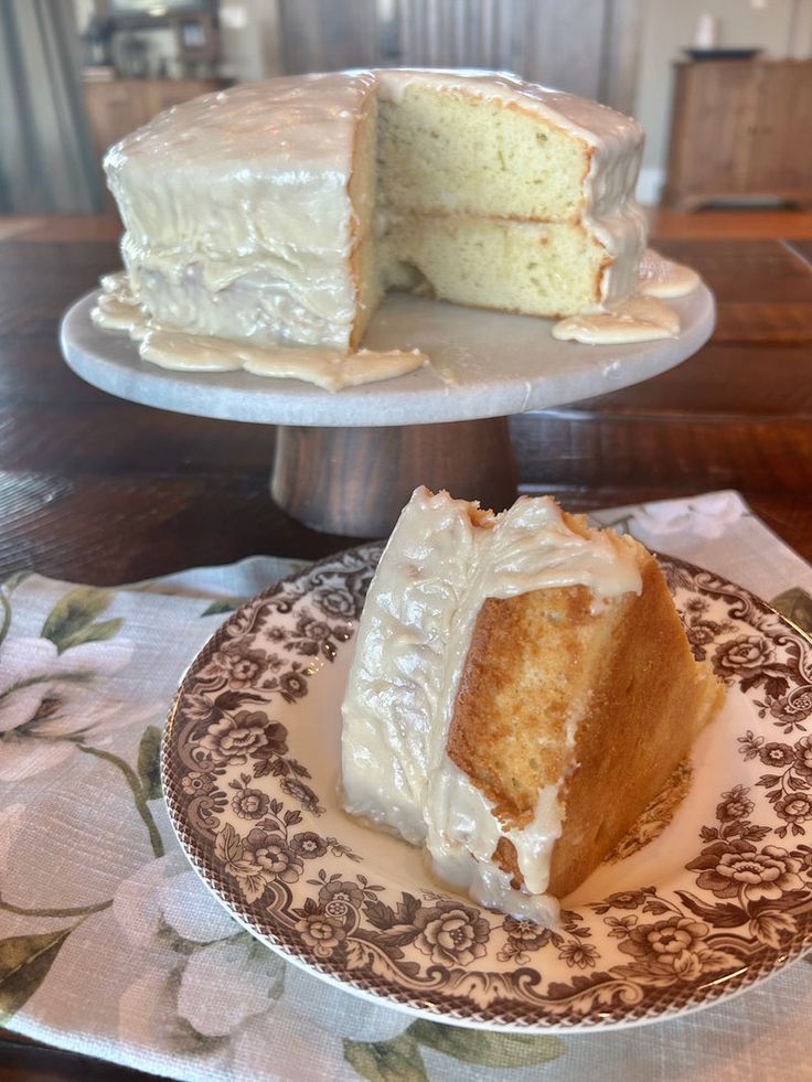 a piece of cake sitting on top of a white plate next to a slice of cake