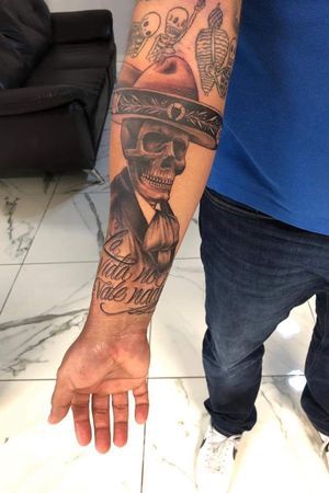 a man with a skull tattoo on his arm