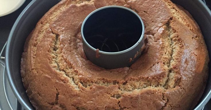 a cake in a pan with a cup on top