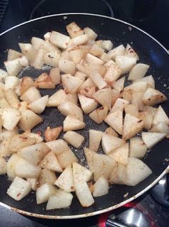 potatoes being cooked in a frying pan on the stove