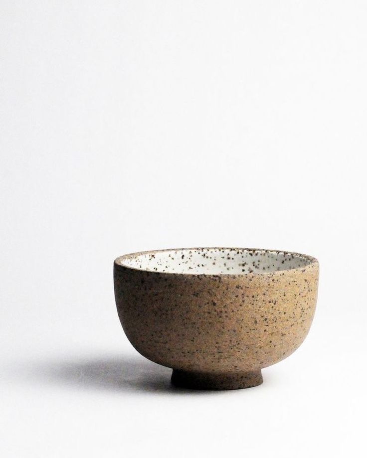 a brown and white bowl sitting on top of a table