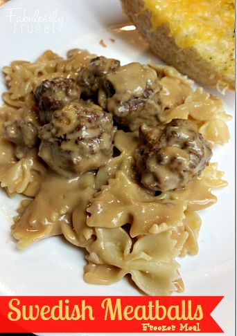 some meatballs and noodles are on a white plate with bread in the back ground