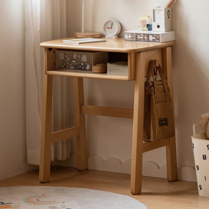 a small wooden desk in the corner of a room with a teddy bear on it