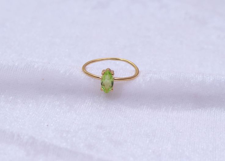 "Materials Gold, Rose gold, White gold Gemstone: Natural Peridot Peridot Ring / 14k Gold Peridot Wedding Ring / Anniversary Ring / Marquise Ring / Stacking Ring / Dainty Ring / Gemstone Ring / Prong set Item Details * Made to Order * Material: 14K Solid Gold (If 18K is needed, please inquire) * Gold Color Choice: Rose Gold, Yellow Gold, White Gold * Total CTW: .50 crt( 4 mm) (varies by size of the ring) * Width of Band: 1.30mm Ready to Ship in 7-10 Business Days * Also available in other gemston Gold Marquise Ring With Birthstone, Stackable Yellow Gold Peridot Jewelry, Stackable Peridot Wedding Jewelry, Yellow Gold Peridot Stackable Rings For Wedding, Yellow Gold Peridot Stackable Rings For Anniversary, Oval Peridot Ring In Yellow Gold, Wedding Stackable Peridot Rings, Yellow Gold Peridot Ring For May Birthstone, Oval Yellow Gold Peridot Rings