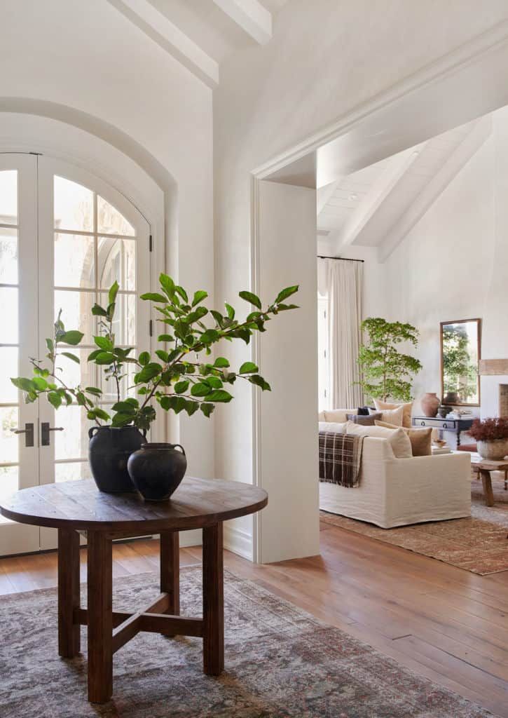 the instagram page shows an image of a living room with white walls and wood floors