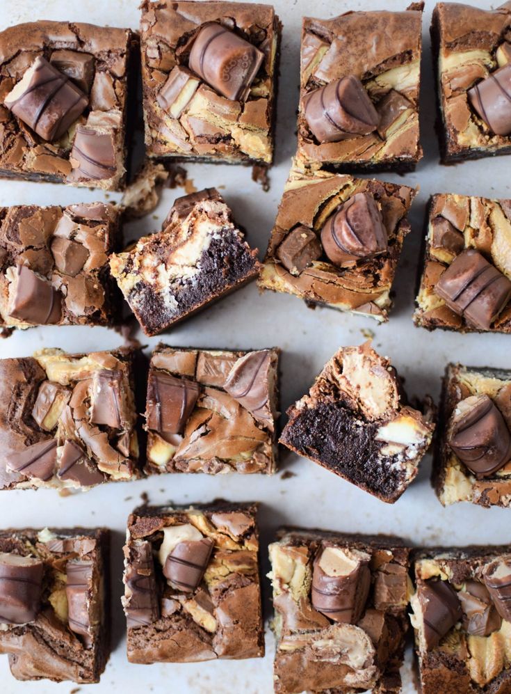 chocolate and peanut butter brownies are arranged on a baking sheet, ready to be eaten