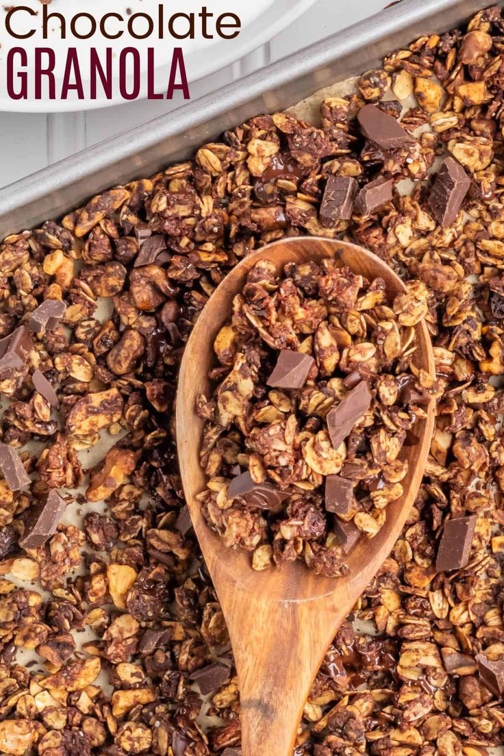 chocolate granola in a wooden spoon on top of a baking pan with the title above it