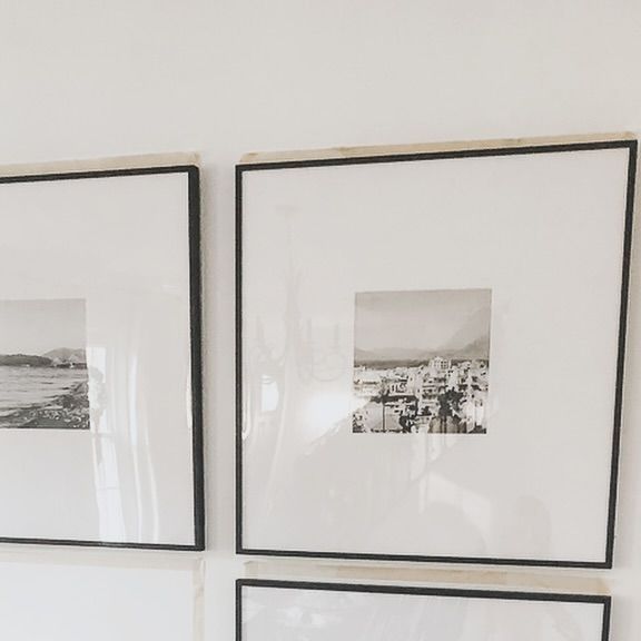 three black and white pictures hanging on the wall