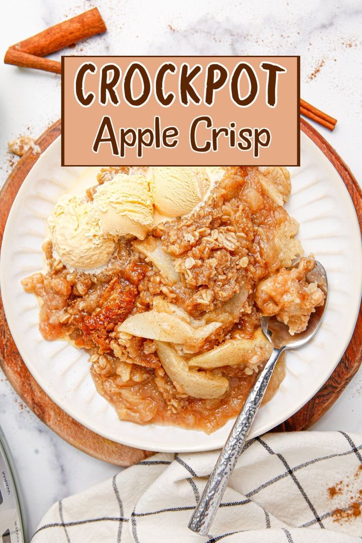 crockpot apple crisp on a white plate with cinnamon sticks and an ice cream scoop