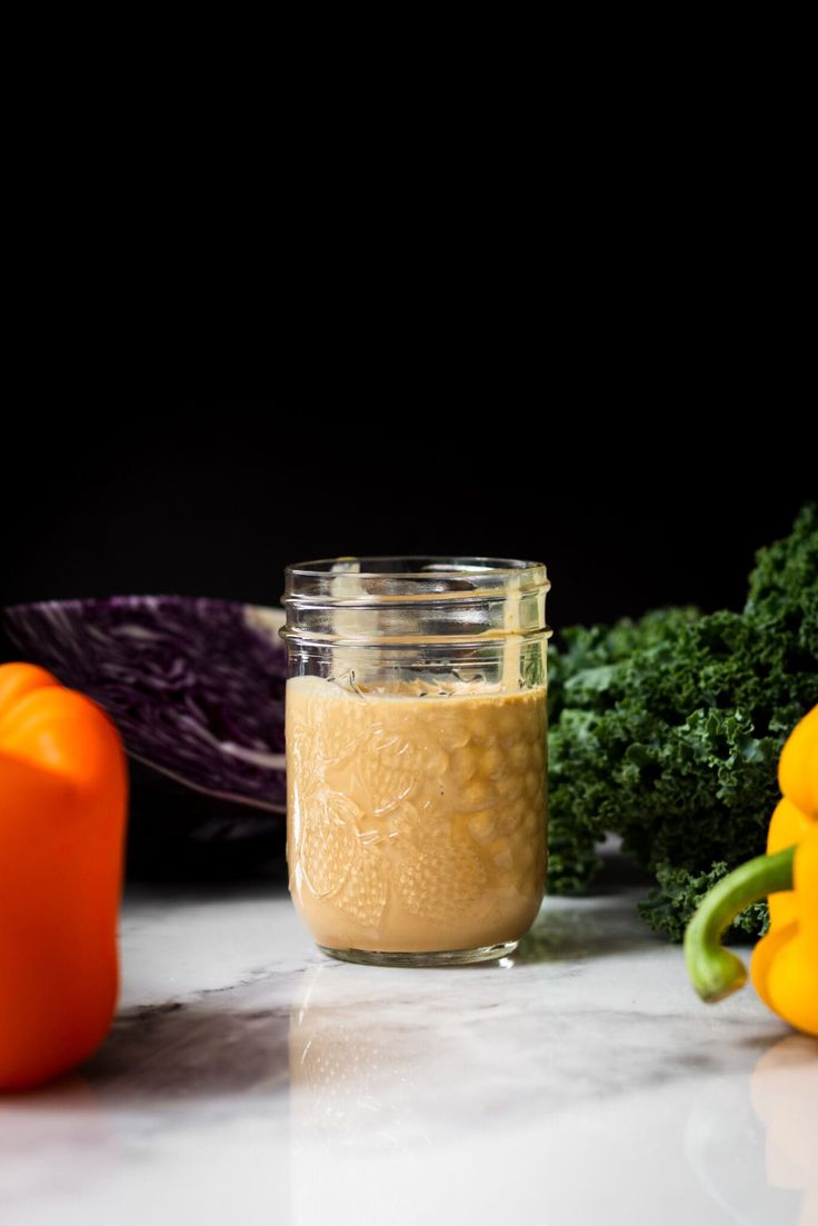 an assortment of vegetables are sitting on a counter top, including peppers and broccoli