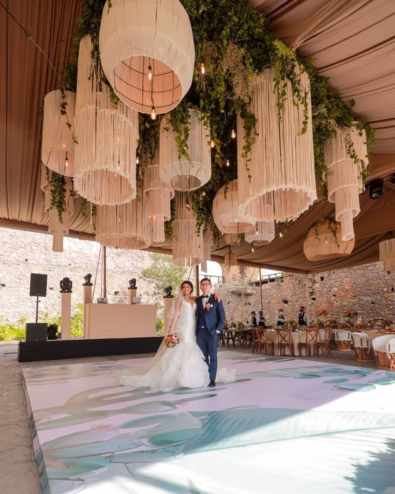 a bride and groom walking down the aisle at their wedding reception in an outdoor venue