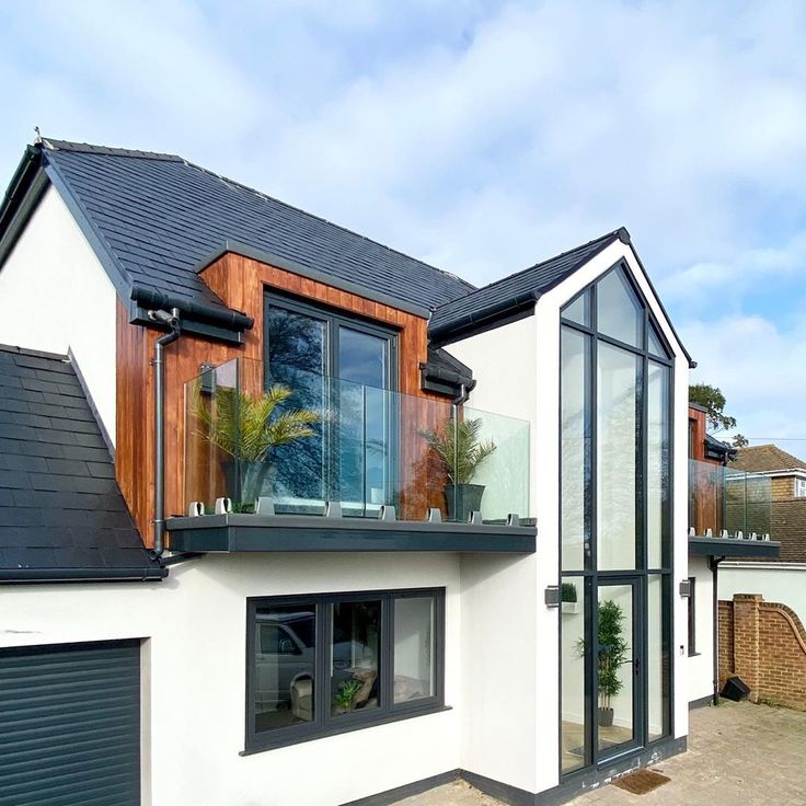 a white house with black roof and windows