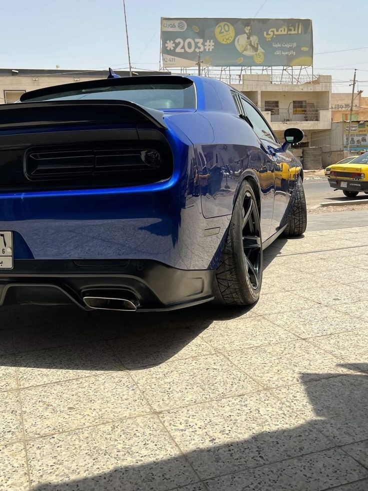 the rear end of a blue sports car