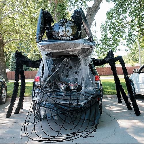 a car decorated for halloween with spider legs