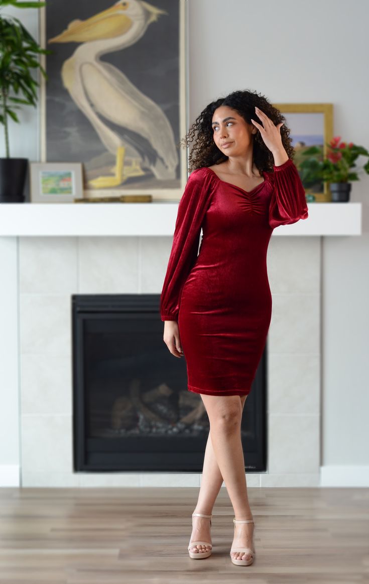 Enjoy the luxurious velvety fabric of the new Nonet Dress! Featuring elegant bishop sleeves and a flattering knee-length fit, this dress is perfect for your upcoming holiday events. Available in Caramel and Red Wine. All Poet dresses come with a cardstock poem delivered in a wax-sealed envelope. 🪶 Custom design by Poet Stretchy material Knee length skirt Modest sweetheart neckline Find our size chart here. Care instructions: Machine washable Air-dry for longest life Iron on low heat when necessary Model: Kayla: Size L Caramel | 5'7" Kat: Size S Red wine | 5'10" Fabric: Polyester Velvet Mini Dress For Winter Date Night, Winter Velvet Mini Dress For Date Night, Elegant Velvet Midi Dress For Night Out, Chic Velvet Dinner Dress, Long Sleeve Ruched Velvet Evening Dress, Ruched Long Sleeve Velvet Evening Dress, Elegant Fitted Ruched Velvet Dress, Chic Knee-length Velvet Dress, Elegant Velvet Dress For Date Night