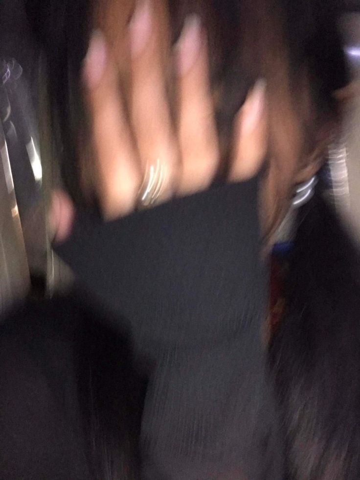 blurry photograph of person holding cell phone in hand