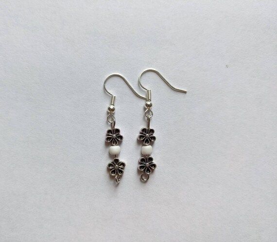 Check out this item in my Etsy shop https://www.etsy.com/listing/1261582058/metal-flower-drop-dangle-earrings Hypoallergenic Silver Drop Flower Earrings, Silver Hypoallergenic Drop Flower Earrings, Handmade Silver Flower Pearl Earrings, Metal Flower Charm Drop Earrings, Metal Drop Earrings With Flower Charm, Adjustable Metal Flower Earrings, Nickel-free Silver Dangle Flower Earrings, Hypoallergenic Metal Flower-shaped Earrings, Silver Nickel-free Dangle Flower Earrings