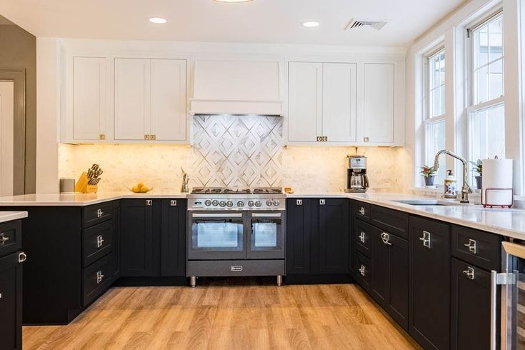 a kitchen with black cabinets and white counter tops is pictured in this image from the front view