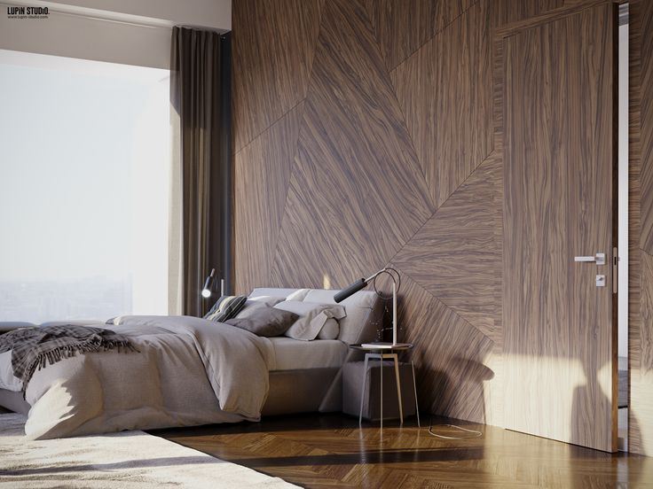 a bedroom with wood paneled walls and flooring