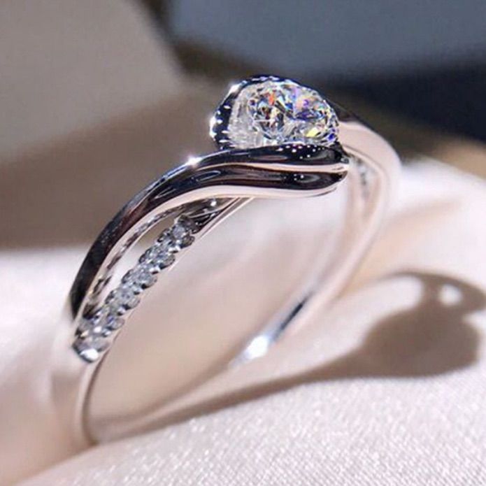 a white gold ring with two diamonds on it