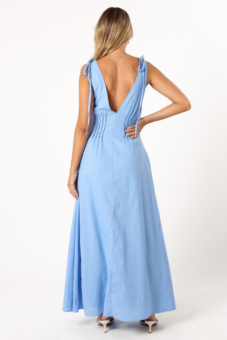 DETAILS  Experience a blend of comfort and style with our Lainey Maxi Dress in Blue. This outfit is defined by its maxi length and a flattering V neckline, complemented by wide straps that close with a double tie for an added touch of elegance. The back mirrors the front with a V design, and the bodice features pleat details for that extra sophistication.  maxi length  v neckline  wide straps with double tie close  back v design  pleat detail on bodice  side invisible zip with hook and eye clasp Satin Dresses Long, Satin Dresses Long Sleeve, V Design, Black Tie Wedding Guests, White Dress Shoes, Tie Maxi Dress, Resort Dresses, Essential Dress, Bridesmaid Outfit