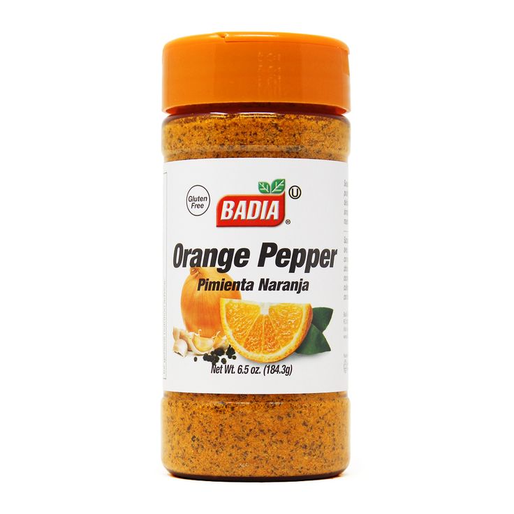 an orange pepper is in a jar on a white background