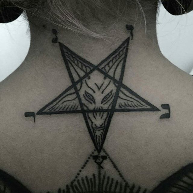 the back of a woman's neck with a pentagramil tattoo on it