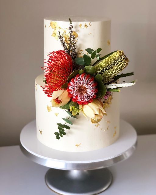 a white cake with red flowers on it